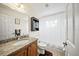 Bathroom featuring a vanity with granite countertop and tub with shower at 9912 Pine Leaf Ln, Dade City, FL 33525