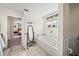 Bright bathroom with a soaking tub, tile flooring, and decor at 9912 Pine Leaf Ln, Dade City, FL 33525