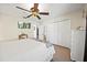 Bedroom with a ceiling fan, closet, and neutral decor at 9912 Pine Leaf Ln, Dade City, FL 33525
