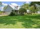 Well-maintained home with mature landscaping and a sprawling green lawn at 9912 Pine Leaf Ln, Dade City, FL 33525