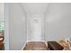 Bright foyer with hardwood floors, white door, and a decorative rug creating an inviting entrance at 9912 Pine Leaf Ln, Dade City, FL 33525