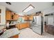 Bright kitchen with stainless steel appliances, granite counters and tile flooring at 9912 Pine Leaf Ln, Dade City, FL 33525