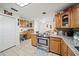 Spacious kitchen with stainless steel appliances, custom cabinets, and granite countertops at 9912 Pine Leaf Ln, Dade City, FL 33525