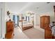 Spacious main bedroom features carpet, ceiling fan, and custom wooden furniture at 9912 Pine Leaf Ln, Dade City, FL 33525