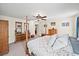 Cozy main bedroom features carpet, ample lighting, and custom wooden furniture at 9912 Pine Leaf Ln, Dade City, FL 33525