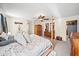 Comfortable main bedroom featuring ceiling fan, ensuite, and wood furnishings at 9912 Pine Leaf Ln, Dade City, FL 33525