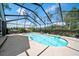 Inviting screened-in pool with clear blue water and ample deck space for relaxation and entertainment at 9912 Pine Leaf Ln, Dade City, FL 33525