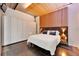 Bright bedroom featuring a platform bed with wood accent wall and concrete floors at 101 S 12Th St # 318, Tampa, FL 33602