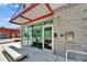 Modern building entrance with glass doors, red awning, and an address plaque, welcoming residents and visitors at 101 S 12Th St # 318, Tampa, FL 33602