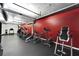 Well-equipped gym featuring various cardio machines, set against a vibrant red wall, ensuring a diverse fitness regimen at 101 S 12Th St # 318, Tampa, FL 33602