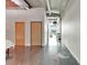 Hallway with concrete floors leads to an open floor plan with exposed ductwork and modern fixtures at 101 S 12Th St # 318, Tampa, FL 33602