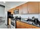 Modern kitchen with stainless steel appliances, granite counters, and wooden cabinets at 101 S 12Th St # 318, Tampa, FL 33602