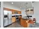 Well-lit kitchen has wood cabinets, granite counters, stainless steel appliances, and island seating at 101 S 12Th St # 318, Tampa, FL 33602