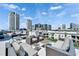 A rooftop deck with seating areas and panoramic views of the city skyline under a blue sky at 101 S 12Th St # 318, Tampa, FL 33602