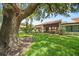 Beautiful backyard view featuring well-maintained lawn, mature trees, and a glimpse of the home's exterior at 107 Seville N Ct, Plant City, FL 33566