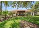 Well-manicured backyard features a spacious lawn and mature trees at 107 Seville N Ct, Plant City, FL 33566