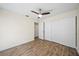 Comfortable bedroom features wood-look flooring, ceiling fan, and closet at 107 Seville N Ct, Plant City, FL 33566