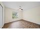 Inviting bedroom with wood-look flooring, ceiling fan, and large window at 107 Seville N Ct, Plant City, FL 33566