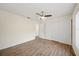 Bedroom with wood floors, fan, closet, and white-painted walls at 107 Seville N Ct, Plant City, FL 33566