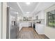 Modern kitchen featuring white cabinets, stainless steel appliances, and tile backsplash at 107 Seville N Ct, Plant City, FL 33566