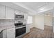 Modern kitchen boasts stainless appliances, mosaic backsplash, and recessed lighting at 107 Seville N Ct, Plant City, FL 33566