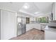 Bright kitchen features stainless steel appliances, granite counters, and wood-look tile flooring at 107 Seville N Ct, Plant City, FL 33566