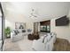 Bright living room featuring neutral walls, vaulted ceilings, and sliding door to screened patio at 107 Seville N Ct, Plant City, FL 33566