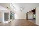 Spacious living room features tile floors, vaulted ceilings, and sliding door to screened patio at 107 Seville N Ct, Plant City, FL 33566