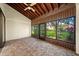 Covered patio features wood ceiling, a tiled floor, and views of the back yard at 107 Seville N Ct, Plant City, FL 33566