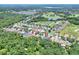 Aerial view of the community showcasing tree-lined streets, houses, and the property's location at 1233 Emerald Hill Way, Valrico, FL 33594