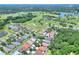 Aerial view of the neighborhood with a golf course and lake in the distance, showcasing the community at 1233 Emerald Hill Way, Valrico, FL 33594