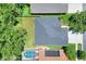 Aerial view of the property showcasing the roof, large backyard, and proximity to neighboring homes and landscaping at 1233 Emerald Hill Way, Valrico, FL 33594