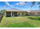 Spacious backyard with a screened lanai and lush green grass, ideal for outdoor activities and relaxation at 1233 Emerald Hill Way, Valrico, FL 33594