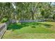 Large backyard featuring lush grass, privacy fence, and mature trees at 1233 Emerald Hill Way, Valrico, FL 33594