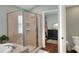Bathroom featuring a glass shower, soaking tub, toilet and a door leading into the closet at 1233 Emerald Hill Way, Valrico, FL 33594