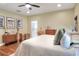Bedroom with neutral walls, wood floors and furnishings, and an ensuite bathroom at 1233 Emerald Hill Way, Valrico, FL 33594