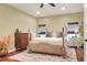 Bedroom featuring a wood bedframe, hardwood floors, area rug, and natural light from two windows at 1233 Emerald Hill Way, Valrico, FL 33594