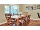 Bright dining area with a wooden table, natural light, and view to the patio at 1233 Emerald Hill Way, Valrico, FL 33594