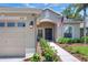 Inviting home entrance featuring a blue door with wreath, landscaped walkway, and a well-lit entry at 1233 Emerald Hill Way, Valrico, FL 33594
