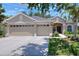 Charming single-story home with a three-car garage, manicured lawn, and inviting entrance, perfect for a Gathering at 1233 Emerald Hill Way, Valrico, FL 33594