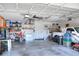 Organized garage interior with ample storage shelving, work area, and space for vehicles and equipment at 1233 Emerald Hill Way, Valrico, FL 33594