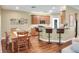 Open kitchen with breakfast bar, wooden cabinets, stainless steel appliances, and adjacent dining area at 1233 Emerald Hill Way, Valrico, FL 33594