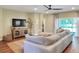 Comfortable living room with a large sectional, media cabinet, and view to the backyard at 1233 Emerald Hill Way, Valrico, FL 33594