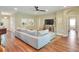 Open living room with hardwood floors, neutral color palette, large sectional sofa, and lots of natural light at 1233 Emerald Hill Way, Valrico, FL 33594
