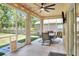 Relaxing screened patio with ceiling fan, lighting, outdoor dining set, and view of yard at 1233 Emerald Hill Way, Valrico, FL 33594