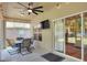 Cozy screened patio featuring lighting, ceiling fan, outdoor dining set, and sliding door at 1233 Emerald Hill Way, Valrico, FL 33594