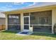 Exterior view of the home's screened patio, featuring pet door, lighting, and ceiling fan at 1233 Emerald Hill Way, Valrico, FL 33594