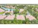 An aerial view shows a charming neighborhood with tree-lined streets, well-manicured lawns, and a tranquil community at 163 Shell Falls Dr, Apollo Beach, FL 33572