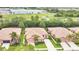 The aerial shot displays a peaceful neighborhood surrounded by greenery, near a road, offering a serene and convenient lifestyle at 163 Shell Falls Dr, Apollo Beach, FL 33572