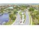 A high angle aerial shows a winding road leading to a lovely community with a small lake and landscaping at 163 Shell Falls Dr, Apollo Beach, FL 33572